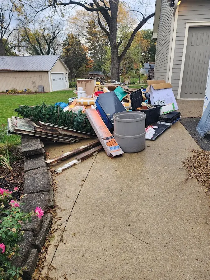Dumpster being loaded with debris for Estate Cleanout Dumpster Rental in Mercer Island
